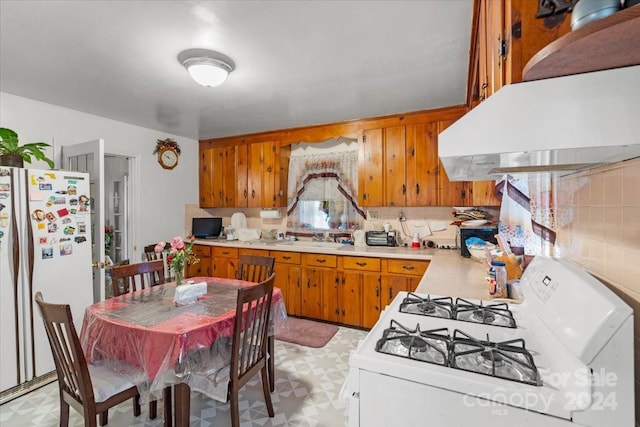 kitchen featuring sink, extractor fan, white appliances, and decorative backsplash