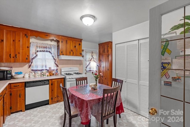 kitchen featuring tasteful backsplash and white appliances