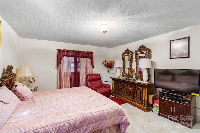 carpeted bedroom with a textured ceiling