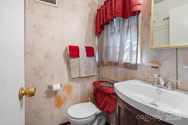 bathroom with toilet and vanity