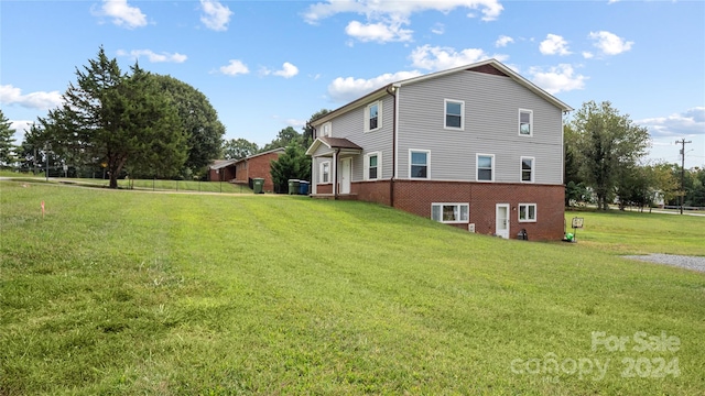 rear view of property with a lawn