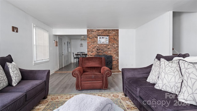 living room featuring ceiling fan and light hardwood / wood-style flooring