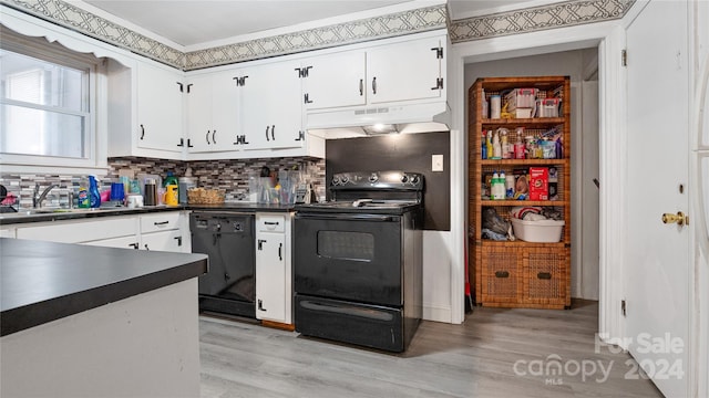 kitchen featuring sink, black appliances, and white cabinets