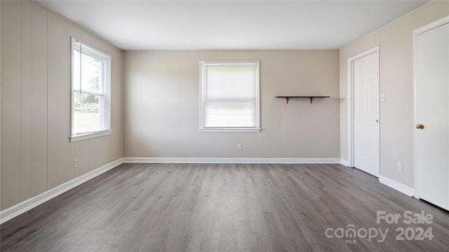 unfurnished room with wood-type flooring