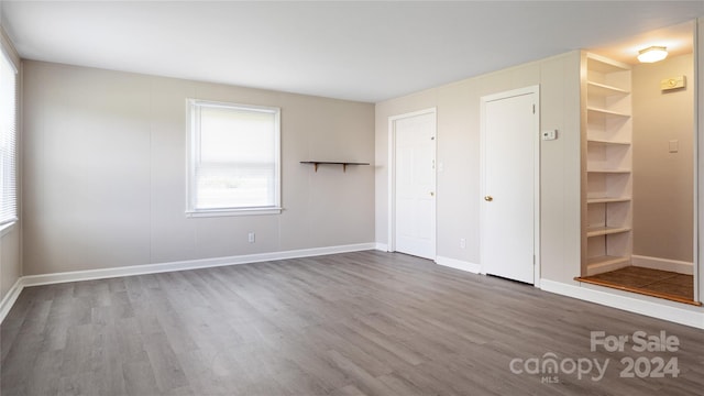 unfurnished bedroom with hardwood / wood-style floors