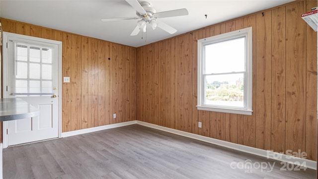 unfurnished room with light hardwood / wood-style flooring, a healthy amount of sunlight, and ceiling fan