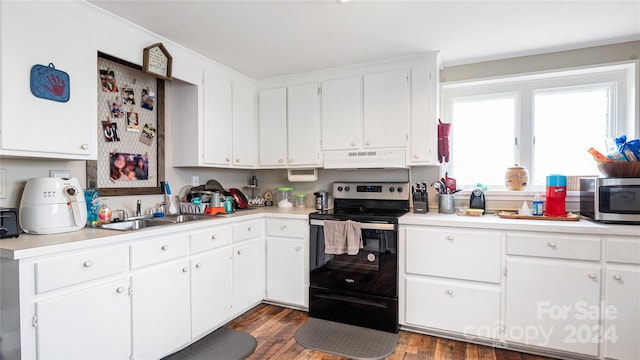 kitchen with black electric range, sink, dark hardwood / wood-style floors, and white cabinets