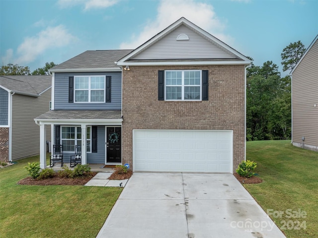 front of property with a porch, a garage, and a front yard