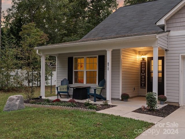 exterior space with a yard and covered porch