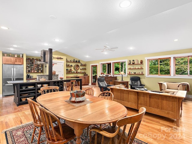 dining space featuring lofted ceiling, light wood-type flooring, and ceiling fan