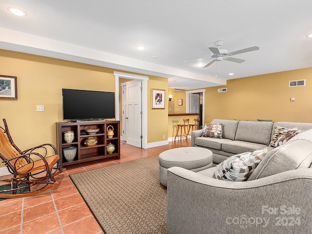 living room with tile patterned floors and ceiling fan