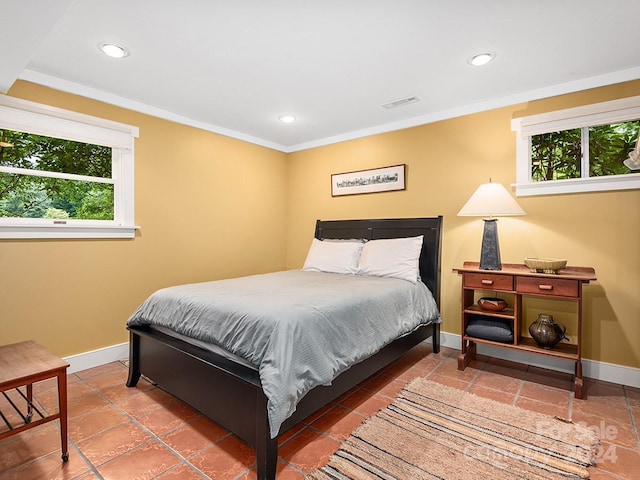 tiled bedroom featuring multiple windows and crown molding