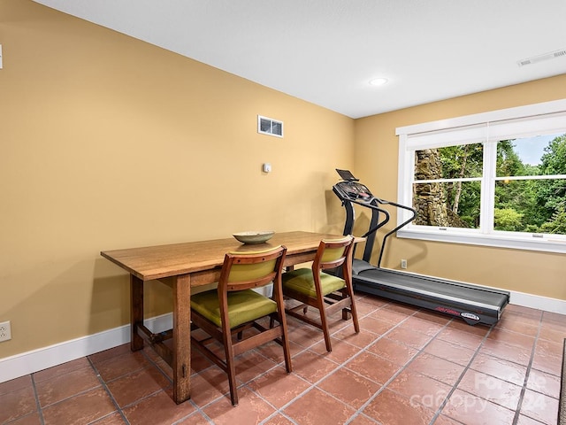 tiled dining room featuring a baseboard heating unit