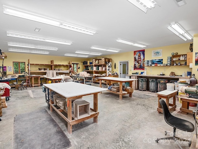 misc room featuring a workshop area and concrete flooring