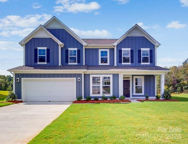 view of front of home featuring a front yard and a garage