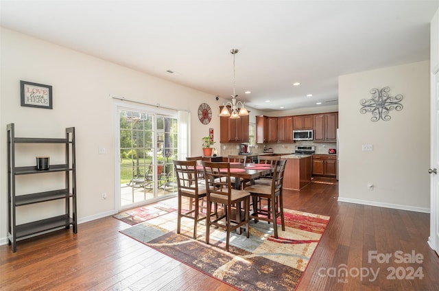 dining room featuring dark wood-type flooring and a notable chandelier