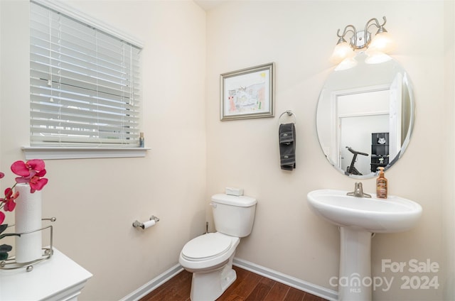 bathroom featuring hardwood / wood-style floors and toilet