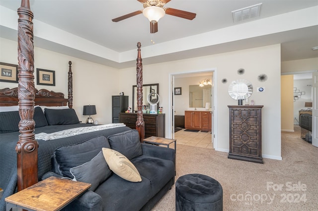 bedroom featuring ensuite bath, ceiling fan, and light colored carpet