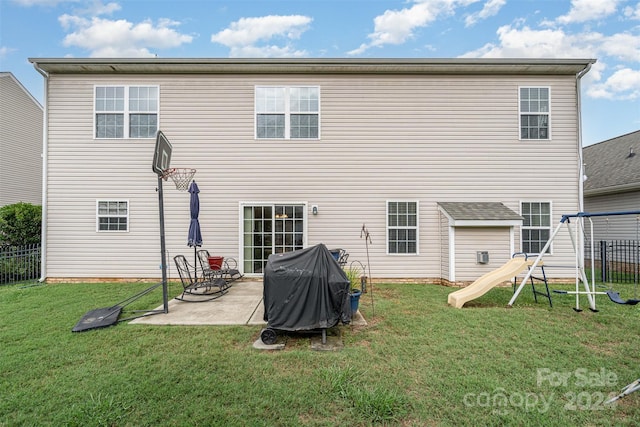 back of house with a lawn, a playground, and a patio area