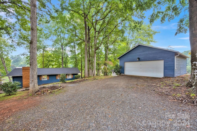 view of property exterior with an outdoor structure and a garage