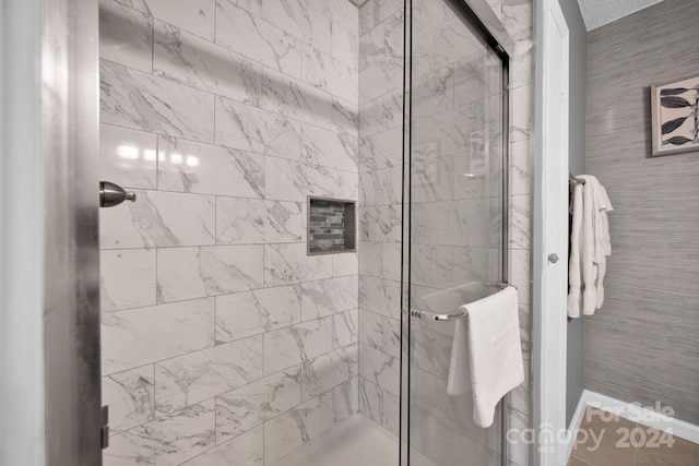 bathroom with a shower with shower door