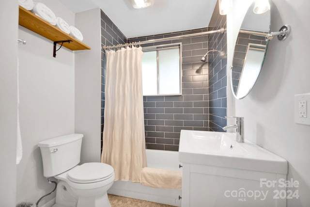 full bathroom with vanity, toilet, and shower / bath combo with shower curtain