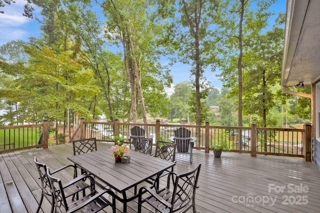 wooden terrace with outdoor dining space