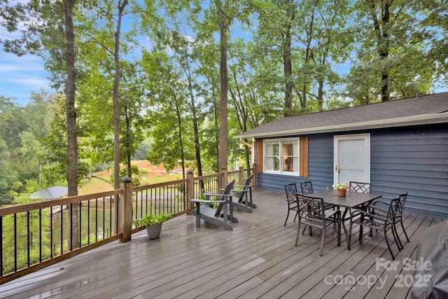 wooden terrace with outdoor dining space