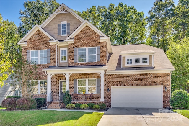 craftsman house with a front lawn and a garage