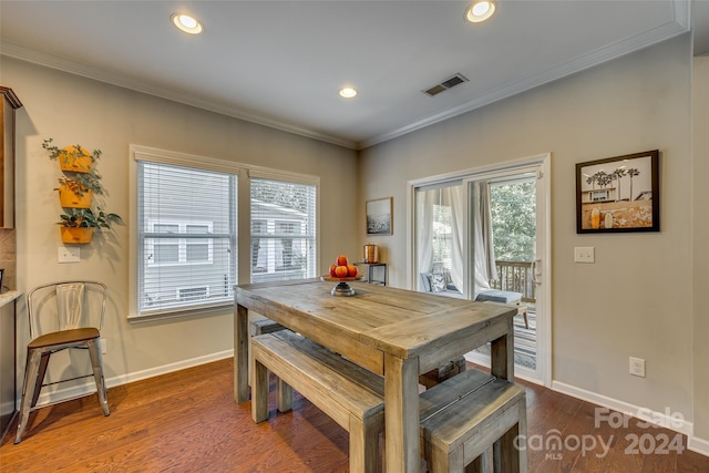 dining room with crown molding and dark wood-type flooring