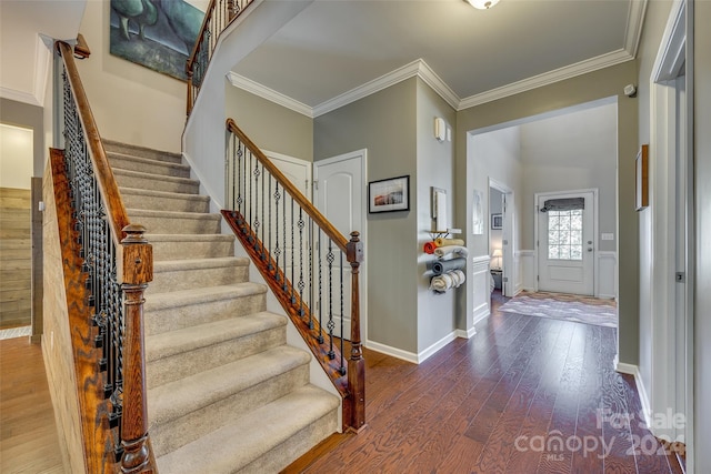 foyer with dark hardwood / wood-style floors and crown molding