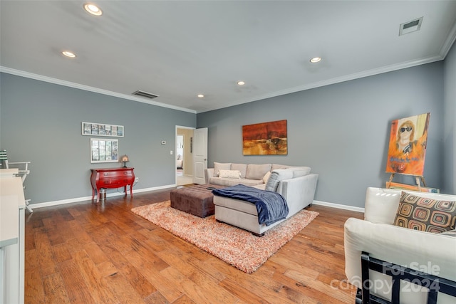 bedroom with crown molding and light hardwood / wood-style floors