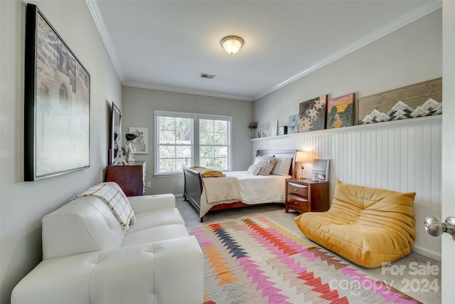 bedroom with crown molding and carpet floors