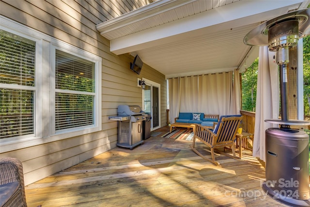 wooden terrace featuring area for grilling