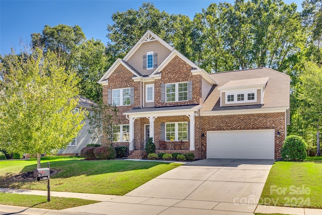 craftsman inspired home with a front yard and a garage