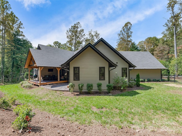 back of property featuring a patio and a lawn