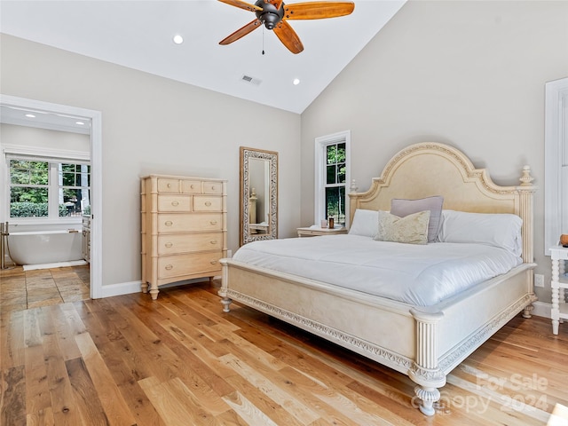 bedroom featuring light hardwood / wood-style floors, high vaulted ceiling, and ceiling fan