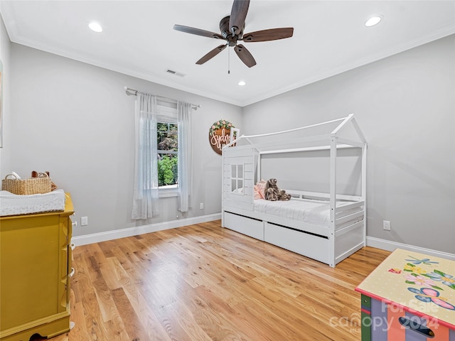 bedroom featuring crown molding, wood-type flooring, and ceiling fan