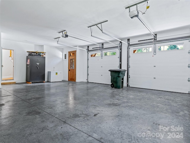 garage with refrigerator and a garage door opener