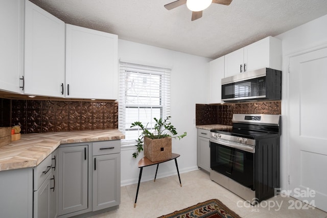 21 Lakeshore Dr, Asheville, NC 28804 - kitchen with stainless steel appliances, a ceiling fan, backsplash, white cabinets, and a textured ceiling