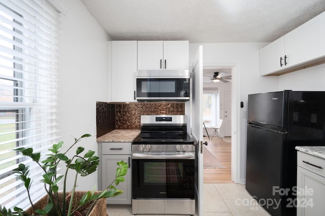 21 Lakeshore Dr, Asheville, NC 28804 - kitchen featuring stainless steel appliances, tasteful backsplash, ceiling fan, white cabinets, and a textured ceiling