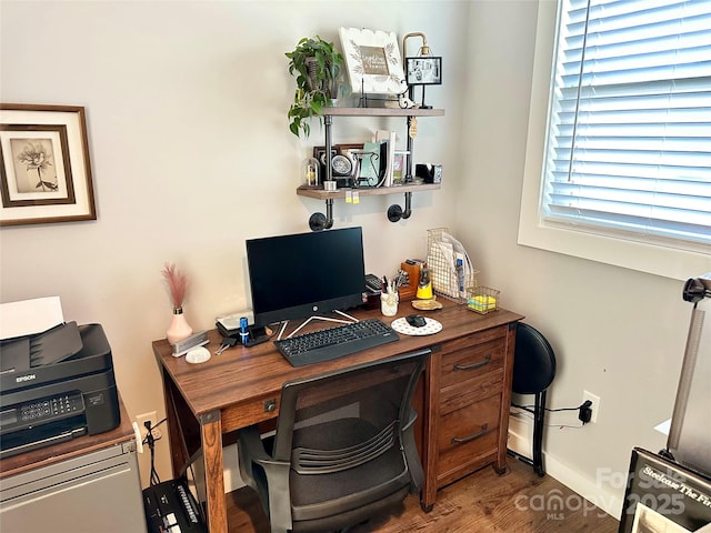 office area featuring baseboards and wood finished floors