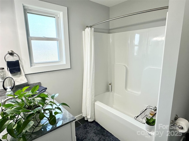 full bathroom featuring shower / bath combo, tile patterned floors, vanity, and baseboards