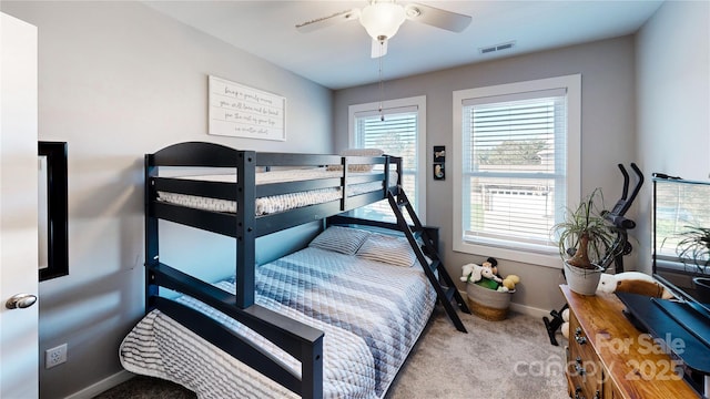 bedroom featuring baseboards, a ceiling fan, visible vents, and carpet floors