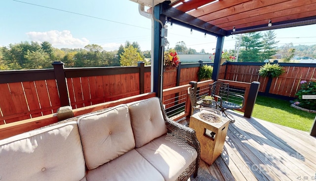 deck with an outdoor living space with a fire pit, a fenced backyard, and a pergola