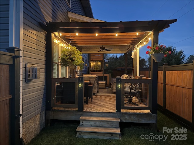 wooden deck with fence and a ceiling fan