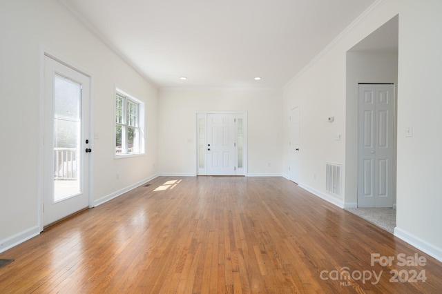 spare room with crown molding and hardwood / wood-style floors