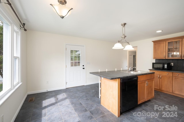 kitchen featuring backsplash, black appliances, plenty of natural light, and a center island with sink