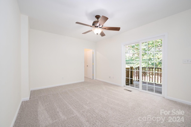 carpeted spare room featuring ceiling fan