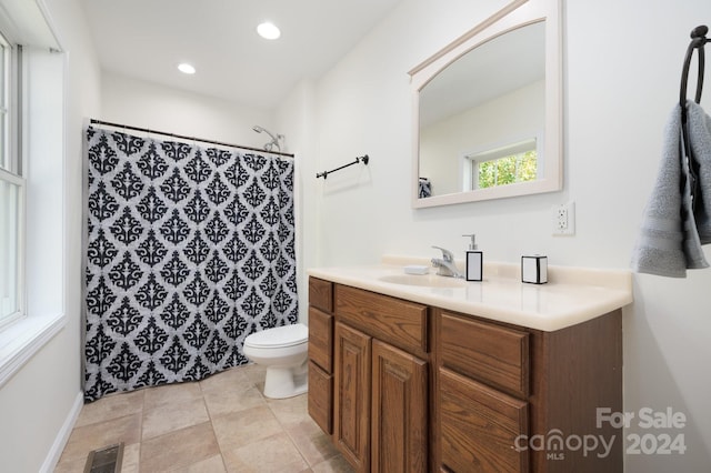 bathroom featuring toilet, vanity, and a shower with shower curtain